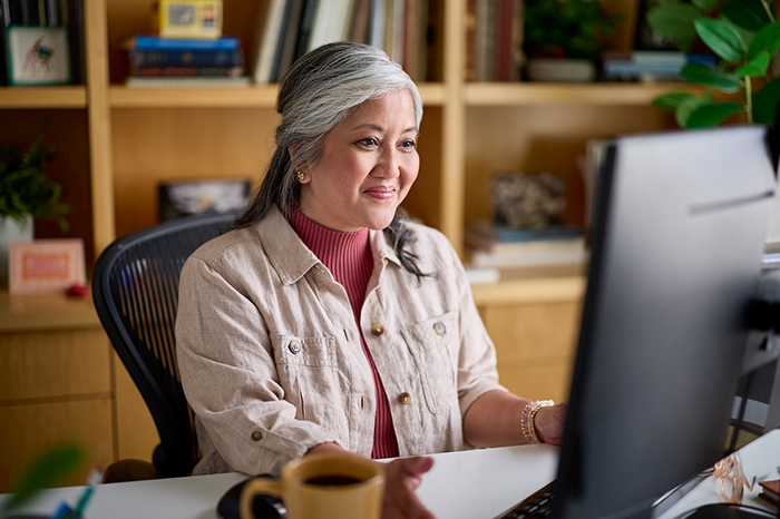 Woman uses computer.