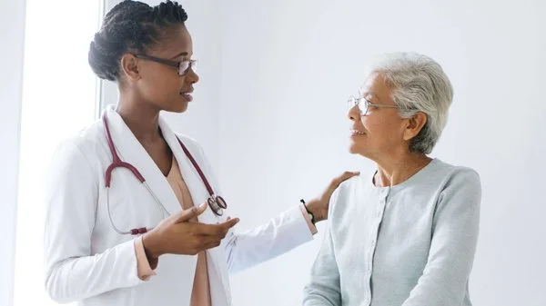 Doctor consults patient.