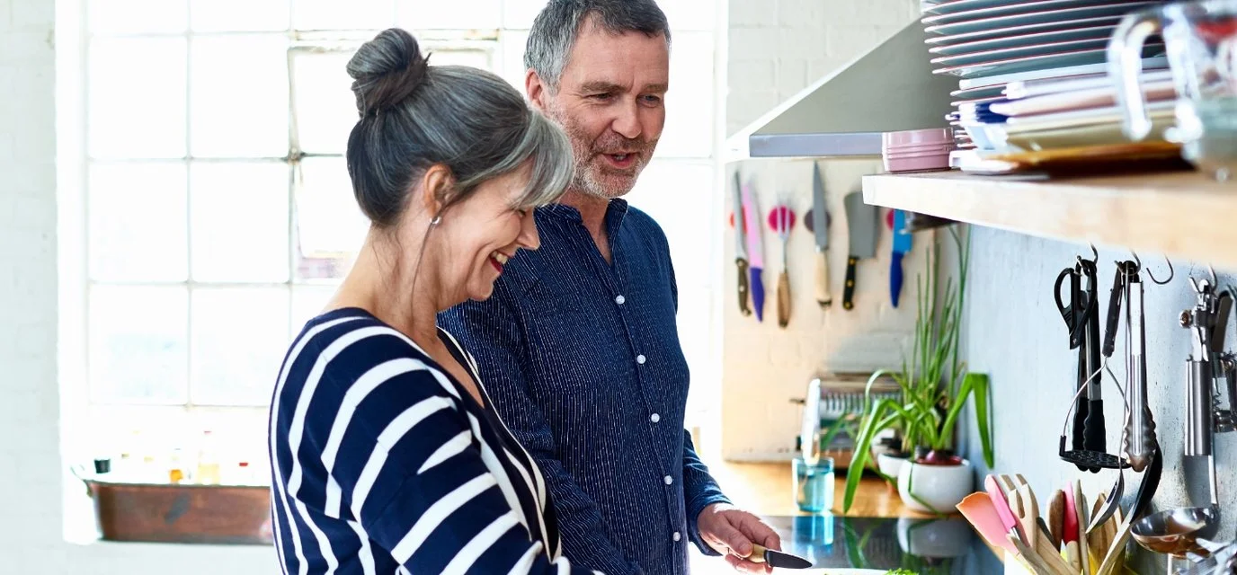couple cooking in a brightly lit kitchen